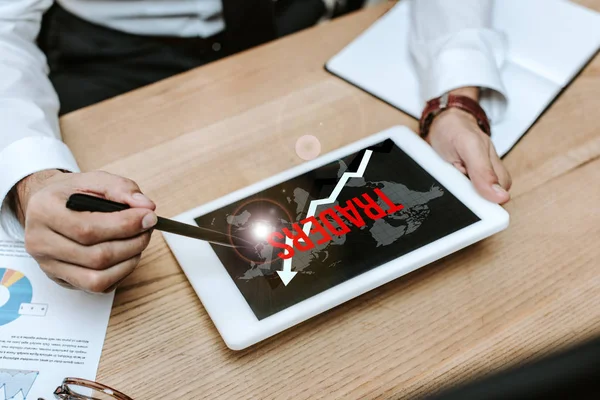 Cropped view of man using digital tablet with traders letters — Stock Photo