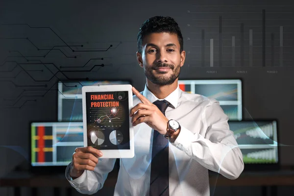 Happy bi-racial trader holding digital tablet with financial protection letters — Stock Photo