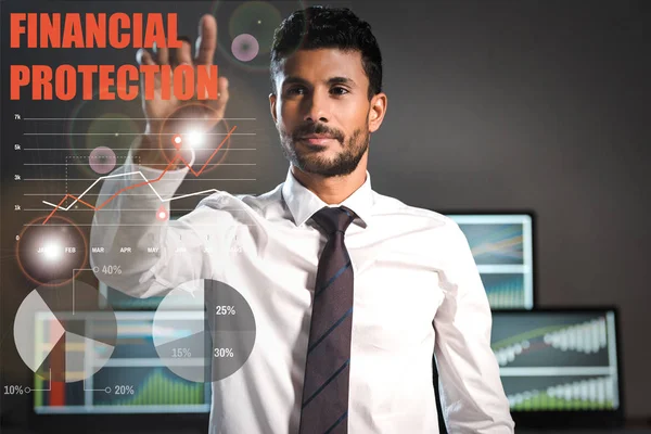Selective focus of bi-racial trader pointing with finger at financial protection letters — Stock Photo