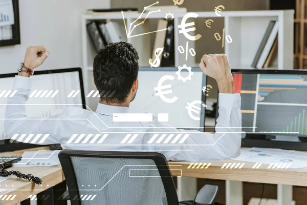 Back view of trader showing yes gesture and sitting near computers with graphs near money signs — Stock Photo