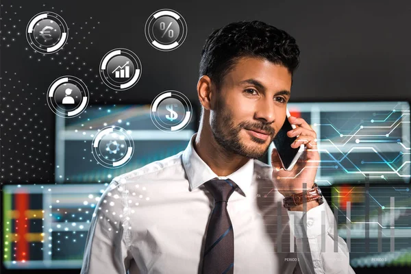 Happy bi-racial trader talking on smartphone near bubbles with charts and graphs — Stock Photo