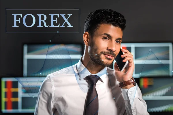 Happy bi-racial trader talking on smartphone near forex letters — Stock Photo