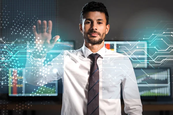 Bi-racial trader gesturing and looking at camera in office — Stock Photo