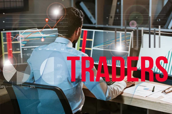 Back view of man working near computer with graphs and traders letters — Stock Photo