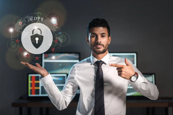 Bi-racial trader pointing with finger at gdpr letters near padlock — Stock Photo