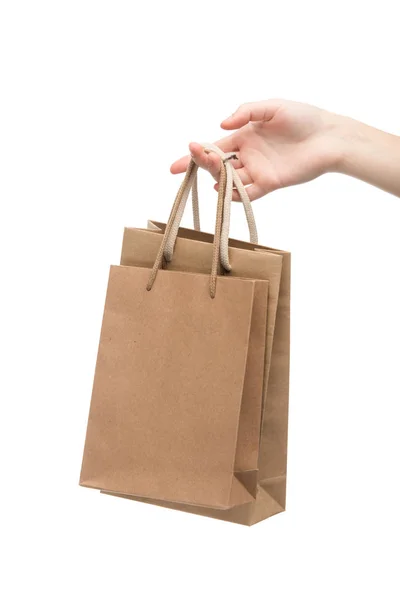 Vista cortada de mulher segurando sacos de compras isolados em branco — Fotografia de Stock