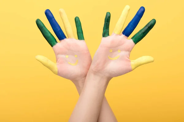 Cropped view of woman with colorful fingers showing palms isolated on yellow — Stock Photo