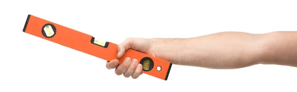 Panoramic shot of man holding spirit level isolated on white — Stock Photo