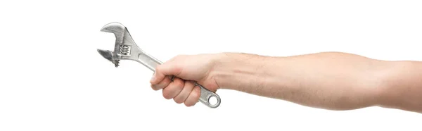 Panoramic shot of man holding spanner isolated on white — Stock Photo