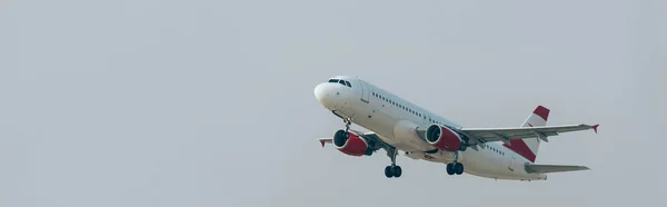 Panoramic shot of airplane with cloudy sky at background — Stock Photo
