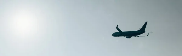 Low angle view of aeroplane with clear sky and sun at background, panoramic shot — Stock Photo