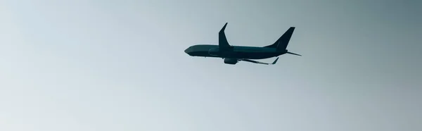 Low angle view of plane taking off in sky, panoramic shot — Stock Photo