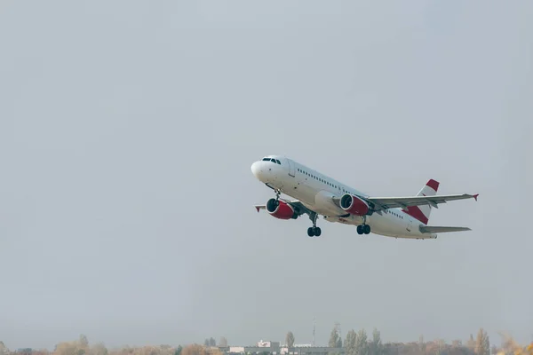 Salida del avión desde la pista del aeropuerto con cielo nublado al fondo - foto de stock