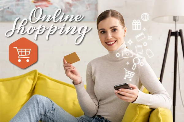 Smiling woman looking at camera while holding smartphone and credit near illustration, online shopping concept — Stock Photo