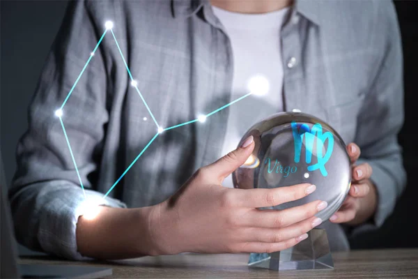 Cropped view of woman using crystal ball near virgo constellation — Stock Photo