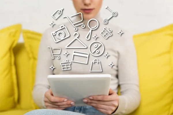 Cropped view of girl using digital tablet near illustration — Stock Photo