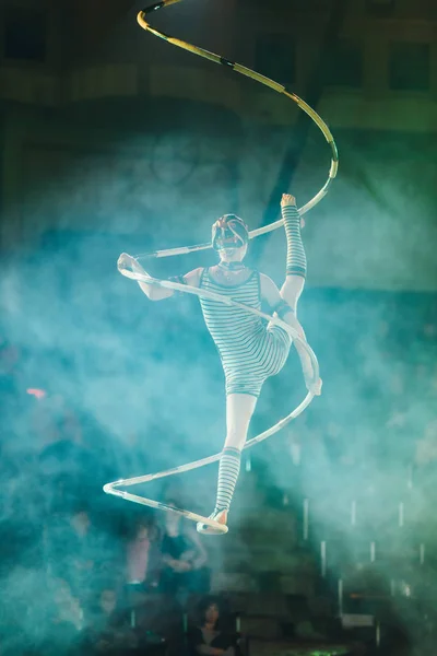 KYIV, UKRAINE - NOVEMBER 1, 2019: Back view of air gymnast performing in smoke in circus — Stock Photo
