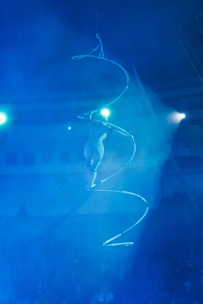 KYIV, UKRAINE - NOVEMBER 1, 2019: Back view of air gymnast performing exercise with equipment in circus — Stock Photo