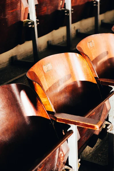 Vista de ángulo alto de asientos de madera vacíos con números en círculo - foto de stock