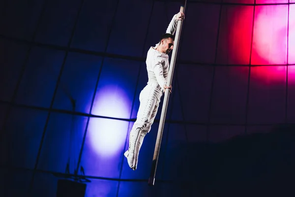 KYIV, UKRAINE - NOVEMBER 1, 2019: Gymnast performing exercise with pole in circus — Stock Photo