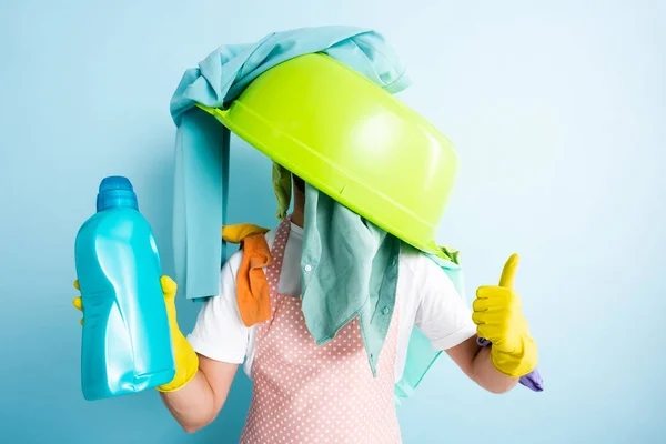 Bol de lavage en plastique et buanderie sale sur l'homme montrant pouce vers le haut — Photo de stock