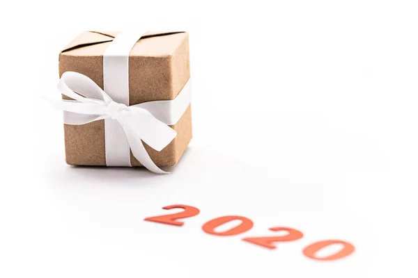 Red number 2020 near gift with ribbon isolated on white — Stock Photo