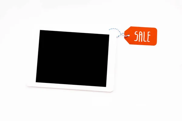 Top view of digital tablet with blank screen with red price tag with sale lettering isolated on white — Stock Photo