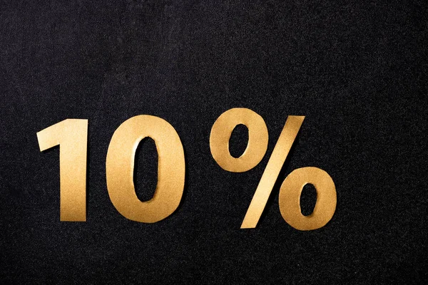 Top view of golden 10 percent signs on black background — Stock Photo