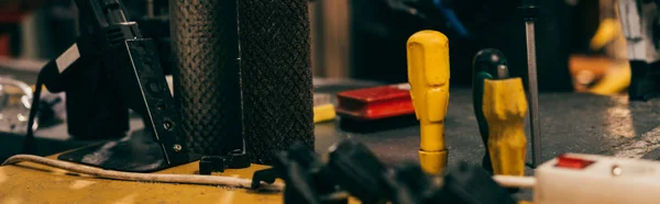 Panoramic shot of screwdrivers on table in repair shop — Stock Photo