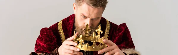 Panoramic shot of king holding crown isolated on grey — Stock Photo