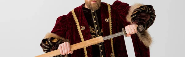 Panoramic shot of king holding sword isolated on grey — Stock Photo