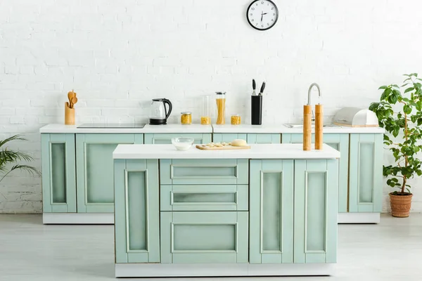 Modern kitchen with raw dumplings on cutting board — Stock Photo