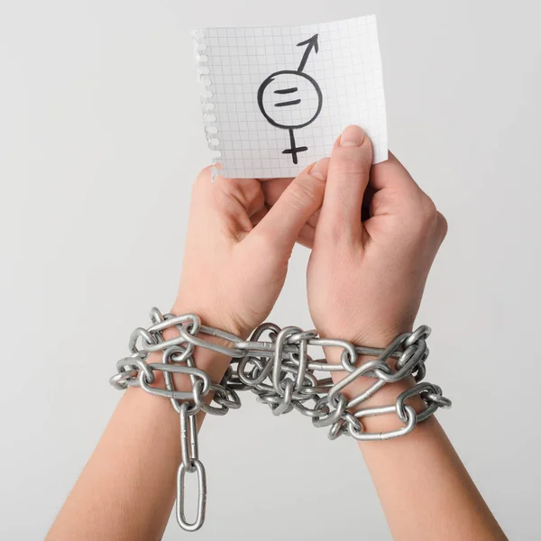 Cropped view of woman in chains holding paper with gender symbol isolated on white, sexual equality concept — Stock Photo