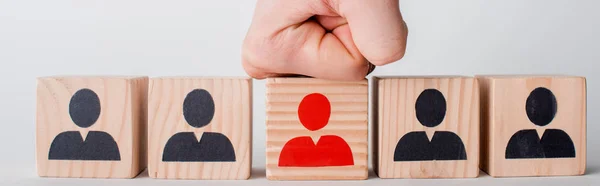 Panoramic shot of man with clenched fist near wooden cubes isolated on white, human rights concept — Stock Photo