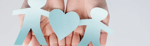 Panoramic shot of young woman holding figures of people cut from paper with heart, human rights concept — Stock Photo