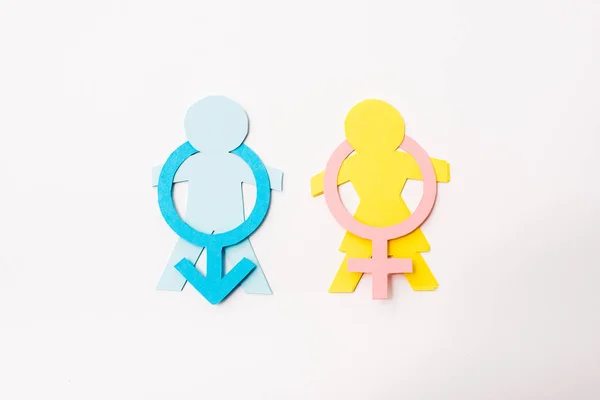Top view of colorful paper cut people near gender signs isolated on white, sexual equality concept — Stock Photo