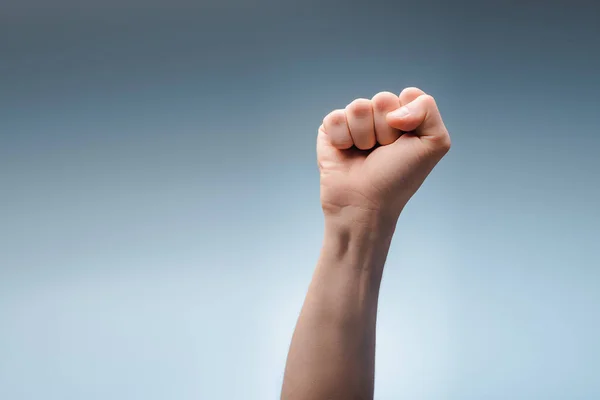 Cropped view of man with clenched fist on grey, human rights concept — Stock Photo