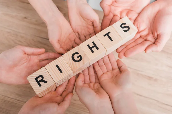 Top view of group holding wooden cubes with rights lettering — Stock Photo