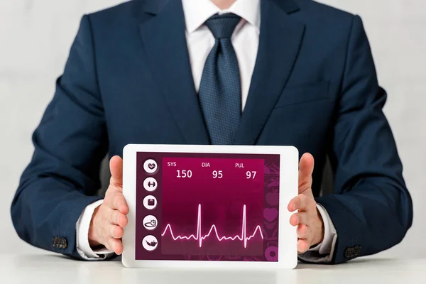 Ausgeschnittene Ansicht eines Geschäftsmannes mit digitalem Tablet mit medizinischer App auf weißem Hintergrund — Stockfoto
