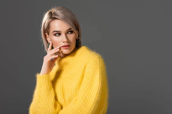 Attractive woman in yellow dress looking away isolated on grey — Stock Photo