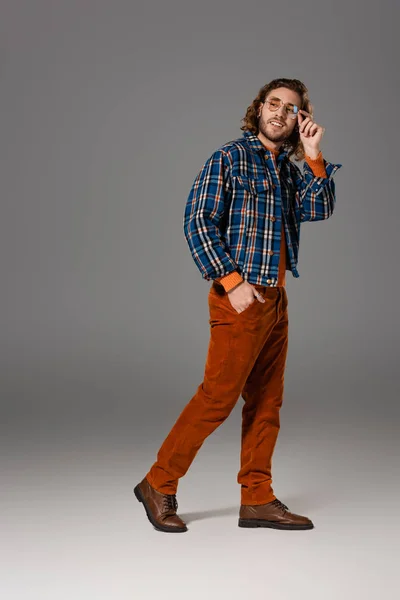 Handsome and smiling man in shirt looking away on grey background — Stock Photo