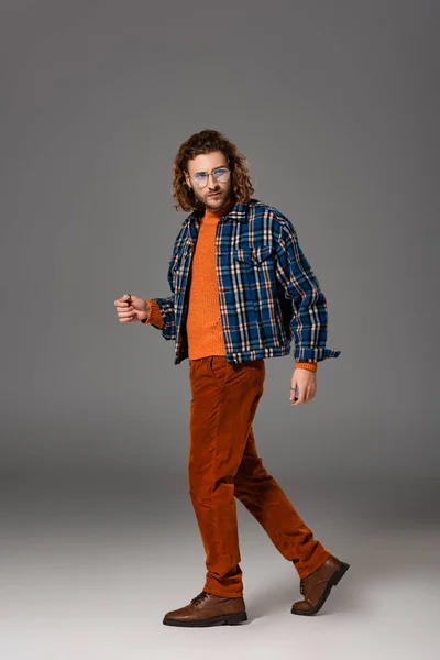 Handsome man in shirt and trousers looking away on grey background — Stock Photo