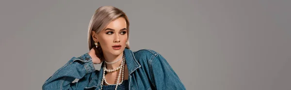 Panoramic shot of attractive woman in denim jacket looking away isolated on grey — Stock Photo