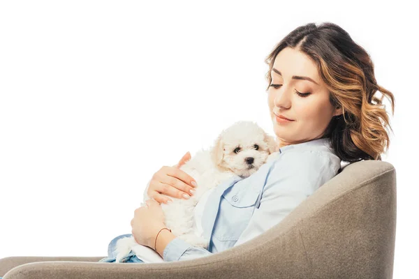 Woman holding Havanese puppy and sitting on armchair isolated on white — Stock Photo
