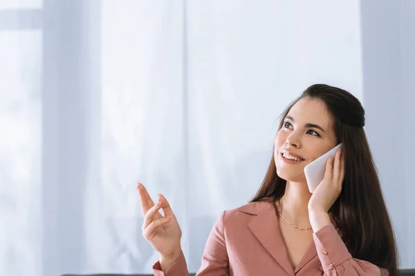 Schöne Frau, die auf dem Smartphone spricht, während sie die Lieferung zu Hause bestellt — Stockfoto