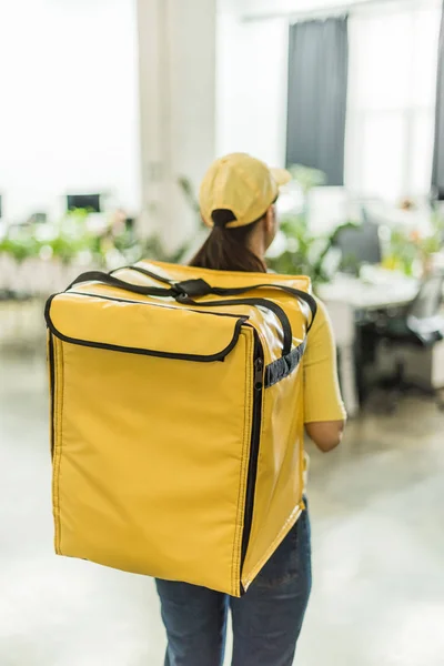 Back view of courier with thermo backpack in office — Stock Photo