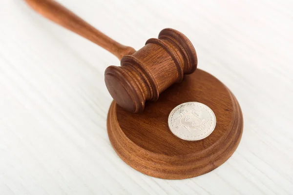 High angle view of wooden gavel and silver coin on table — Stock Photo