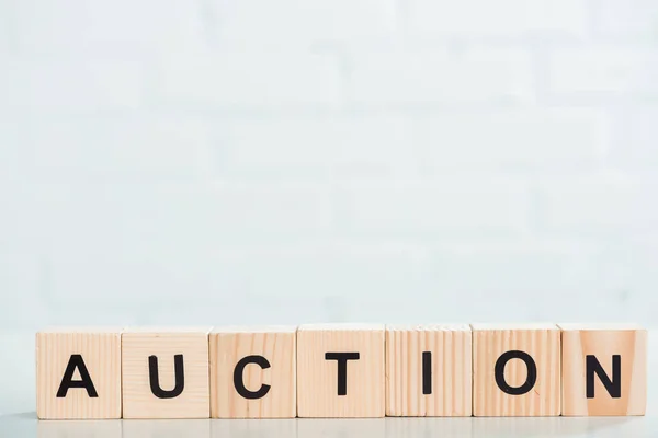Wooden cubes with auction lettering on white background — Stock Photo
