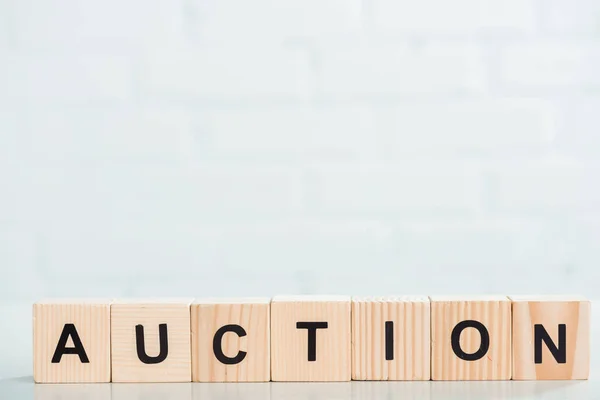 Wooden cubes with auction lettering on white background — Stock Photo