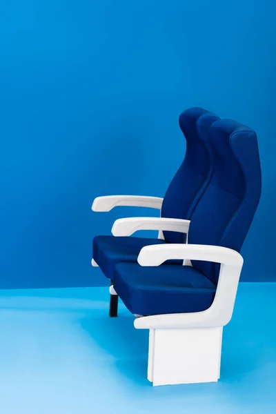 Bright and colorful seats on blue background with copy space — Stock Photo
